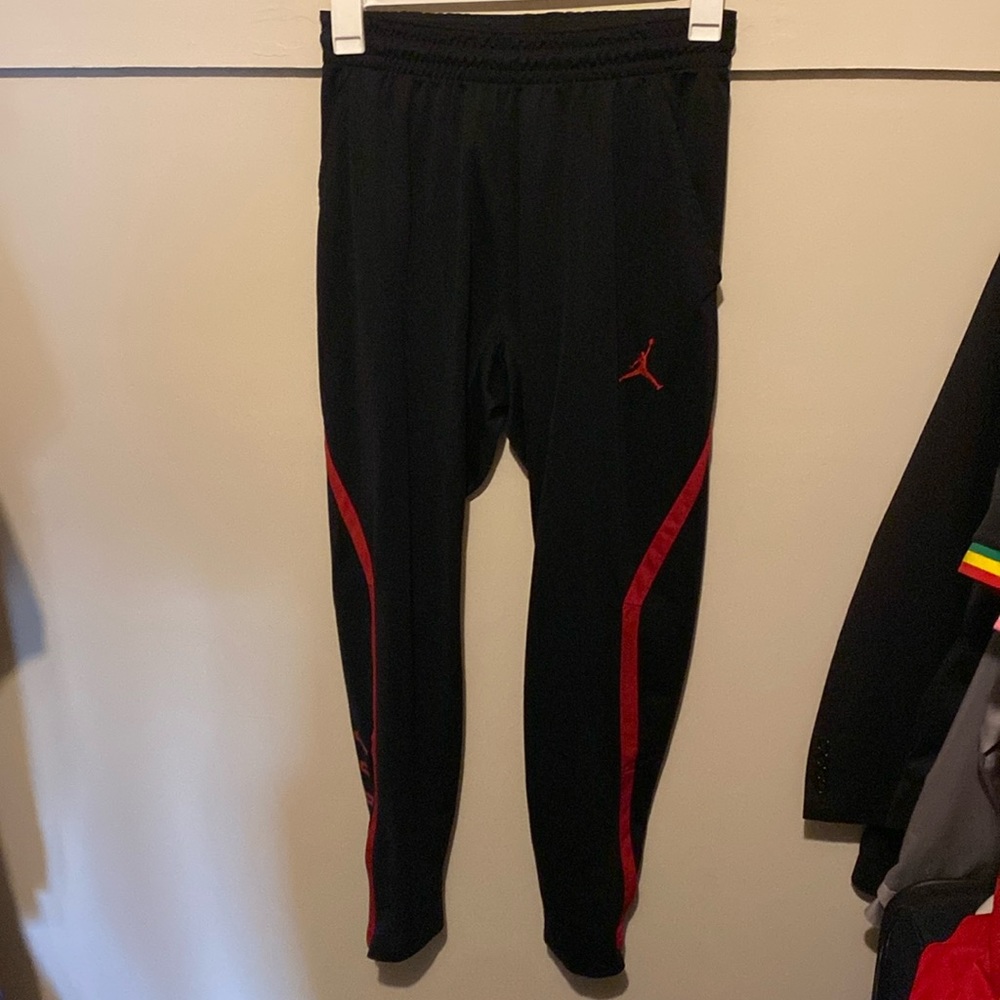 Jordan men’s Black Joggers/red stripe down side. Dri-fit, 100% polyester